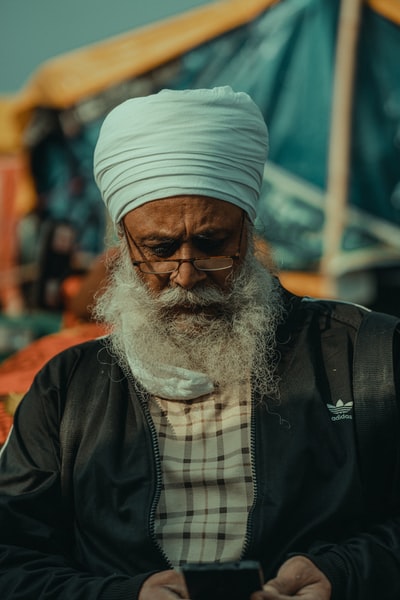 Dressed in a black jacket, wearing a white knitted hat man
